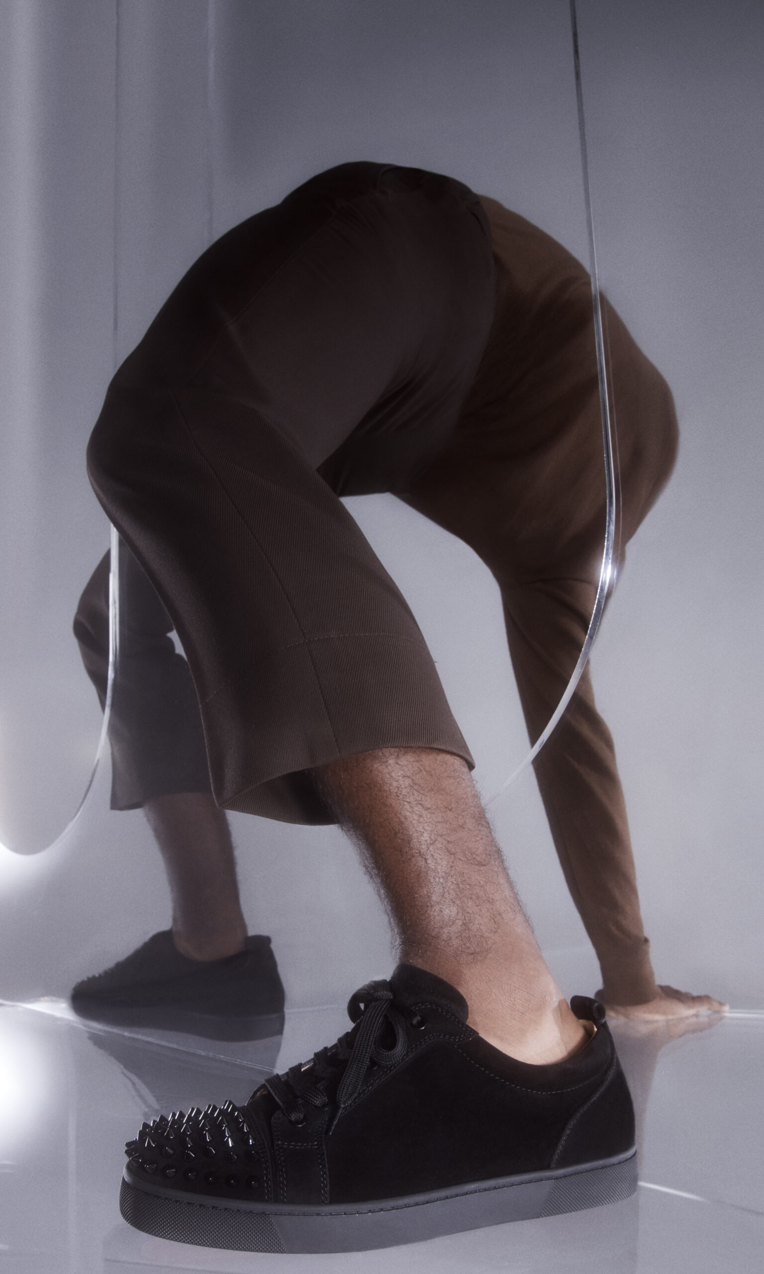 CHRISTIAN LOUBOUTIN BLACK LOUIS JUNIOR SPIKE ORLATO SNEAKERS ON FOOT 